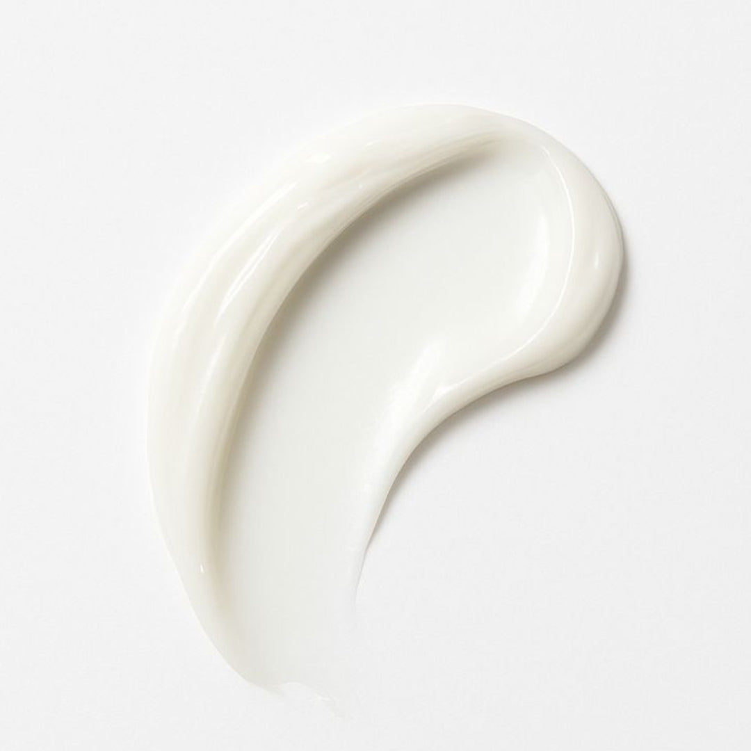 A thick, creamy white product swatch, likely a skincare cream or lotion, swirled on a clean white background.