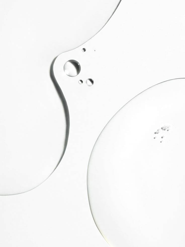 Macro texture of clear peptide skincare serum — minimalist editorial skincare visual from IMEAN