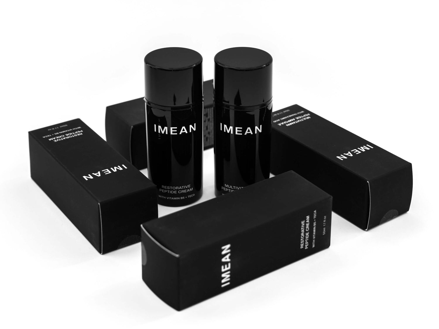 IMEAN Restorative and Multivitamin Peptide Creams with bioengineered natural peptides, shown with black packaging. 