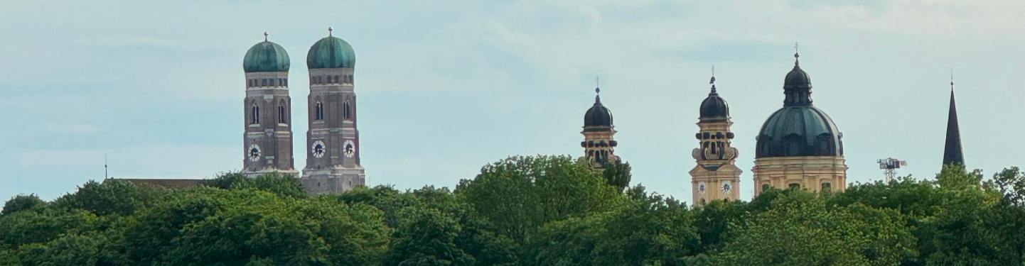 Munich skyline with the twin domes of the Frauenkirche rising above green trees